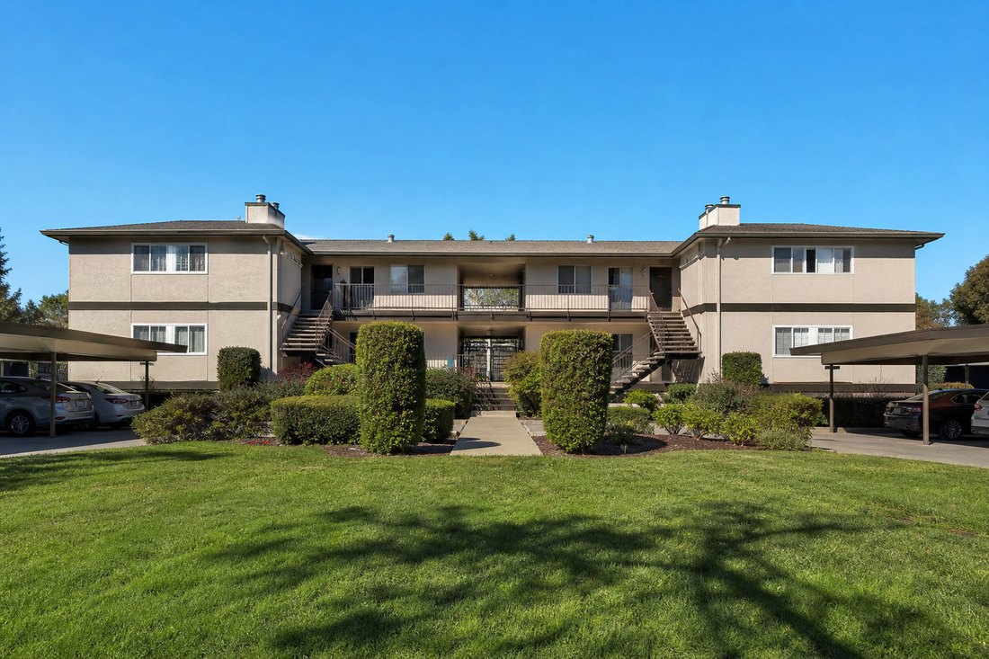 Two-story garden apartment building with carports in southern Alameda County